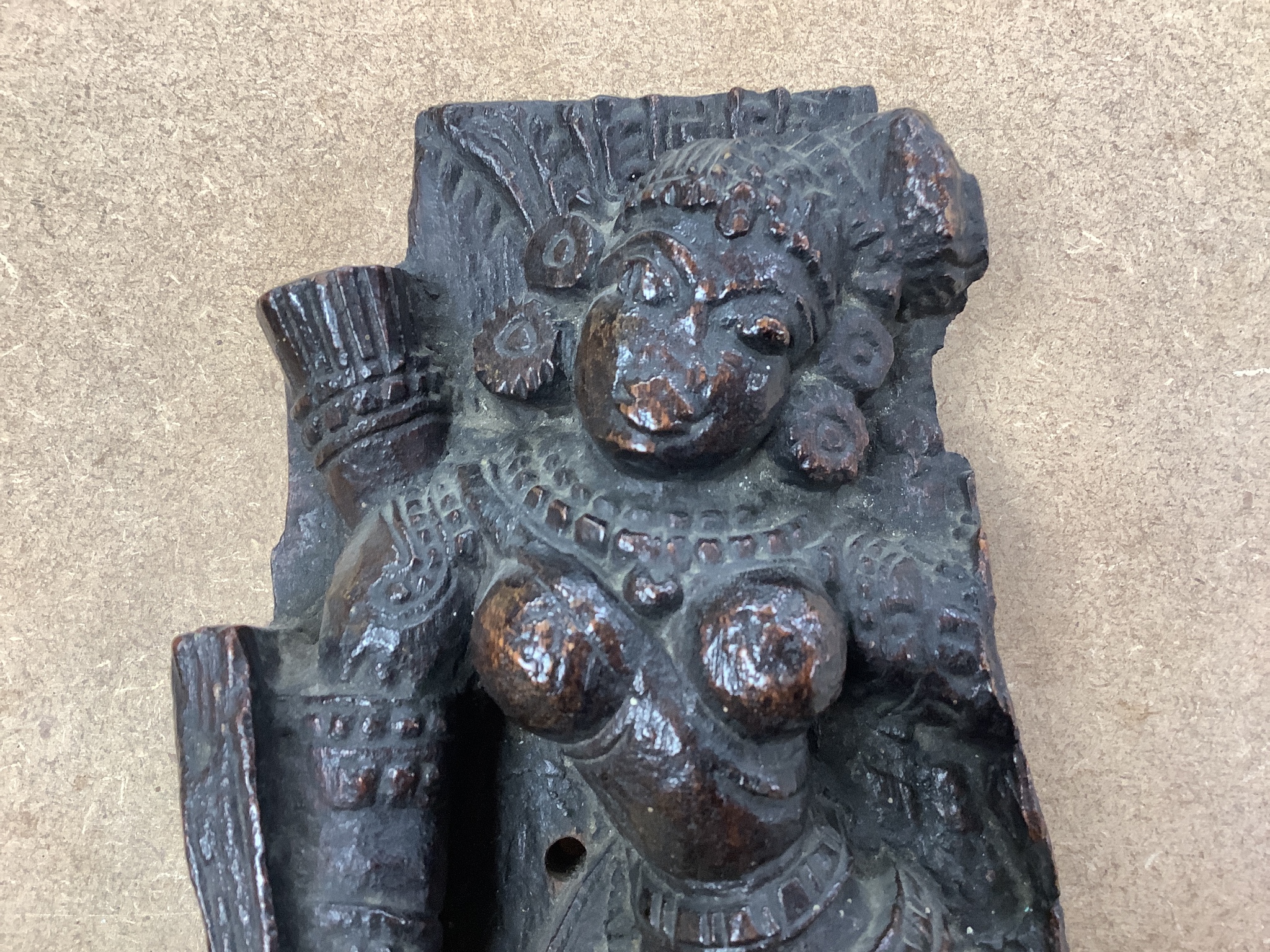 An Indian hardwood figural relief, 18th century or earlier, 28cm, a dagger and two carving knife sets